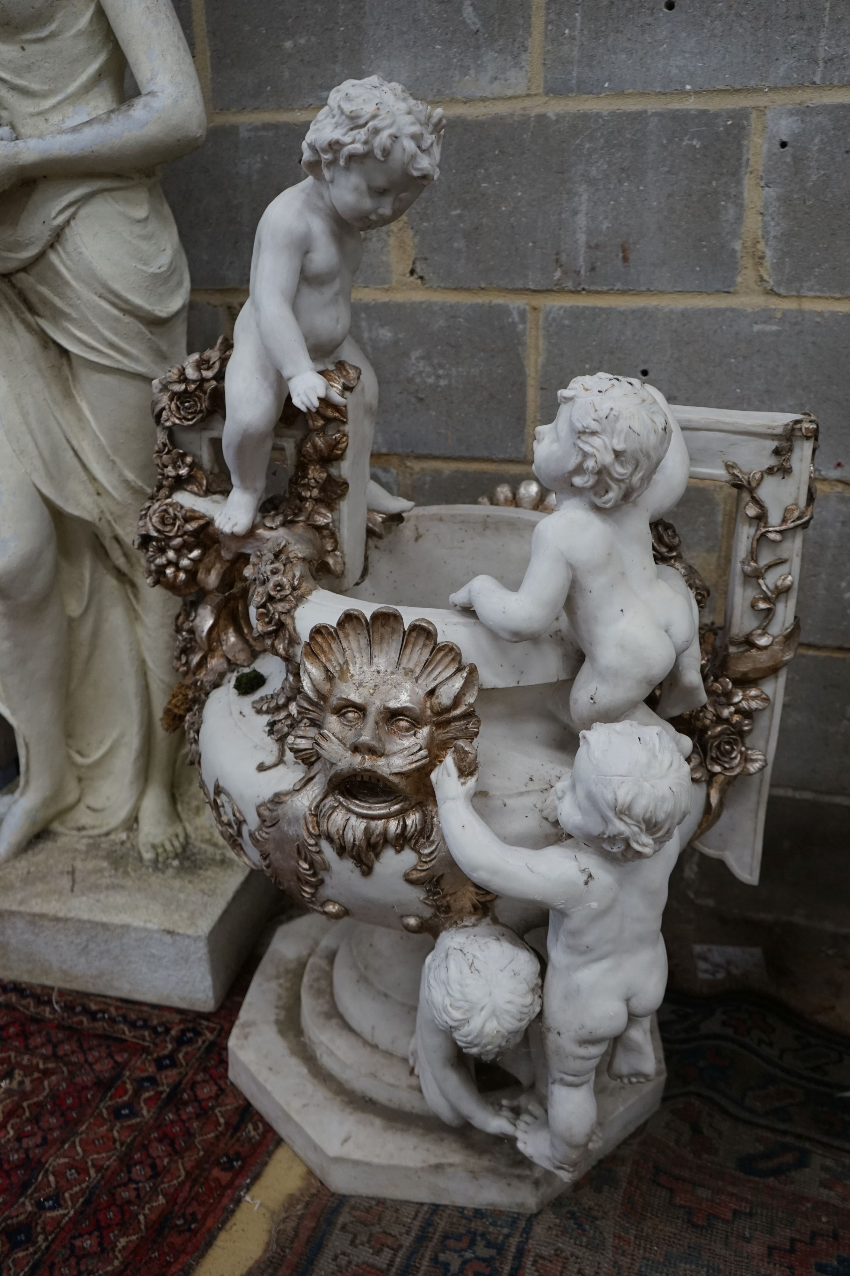 A pair of composition faux marble cherub and mask jardinieres, height 112cm